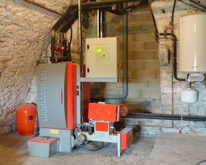 Une chaudière Hargassner a été installée en 2010 à la ferme des Baumes, sous voûte de pierre, photo Frédéric Douard